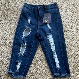 Medium wash, distressed Bermuda shorts